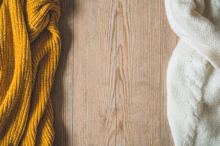 Fall Background with warm sweaters. Pile of knitted clothes. Warm background, knitwear, space for text, Autumn winter concept. Copy Space.の写真素材