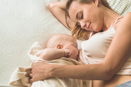 Portrait of a mom and breast feeding baby. Concept breast feeding.
