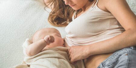 Portrait of a mom and breast feeding baby. Concept breast feeding.の写真素材