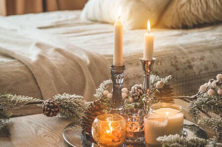 A lot of candles with candlesticks on the home background. Home and home decor. Candles flame. HOME conceptの写真素材