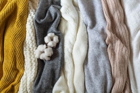 Pile of knitted clothes with cotton, warm background, knitwear, space for text, Autumn winter concept. Copy Space.の写真素材