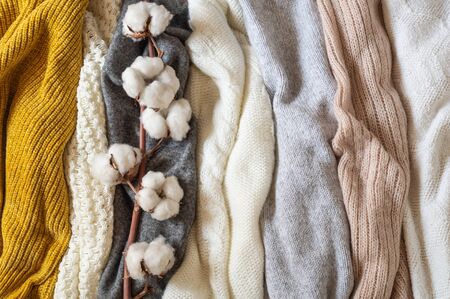 Pile of knitted clothes with cotton, warm background, knitwear, space for text, Autumn winter...