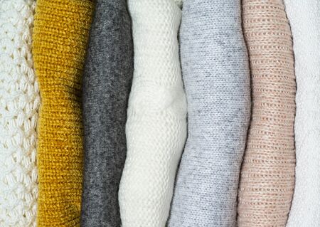 Fall Background with warm sweaters. Pile of knitted clothes. Warm background, knitwear, space for text, Autumn winter concept. Copy Space.の写真素材