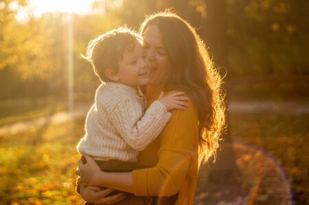 Happy family on autumn walk! Mother and son walking in the Park and enjoying the beautiful autumn natureの写真素材