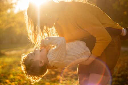 Happy family on autumn walk! Mother and son walking in the Park and enjoying the beautiful autumn natureの写真素材