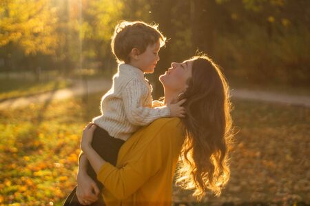 Happy family on autumn walk! Mother and son walking in the Park and enjoying the beautiful autumn natureの写真素材