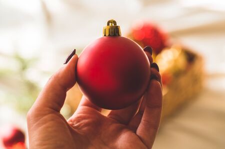 Christmas tree toys in hands women. Winter mood, holiday decorationの写真素材