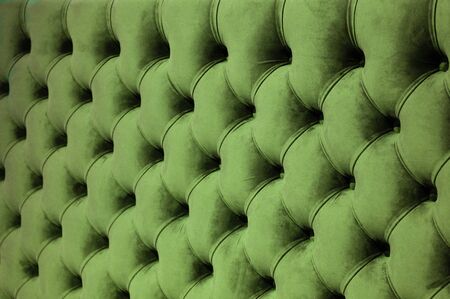 Coach-type velours screed tightened with buttons. Chesterfield style quilted upholstery backdrop close up. Capitone pattern texture backgroundの写真素材