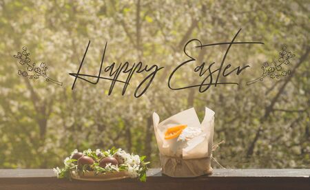 Happy Easter. Congratulatory easter background. Easter cake with easter eggs on a wooden window sill. Holiday Conceptの写真素材