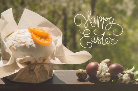 Happy Easter. Congratulatory easter background. Easter cake with easter eggs on a wooden window sill. Holiday Conceptの写真素材