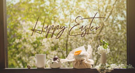 Happy Easter. Congratulatory easter background. Easter cake with easter eggs on a wooden window sill. Holiday Conceptの写真素材