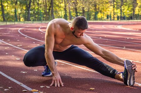 Male model with muscular fit and slim body at the city stadium. Healthy lifestyleの写真素材