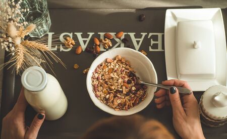Healthy organic nutrition. Woman enjoying breakfast with oatmeal in bed, free space. Concept of...