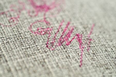 Painted fabric on sofa pink marker. Furniture fabric. Cleaning concept.の写真素材