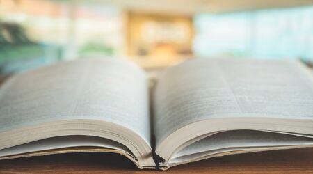 Bible on a background of home interior. The concept of faith, spirituality and religion. Peace, hope, dream conceptの写真素材