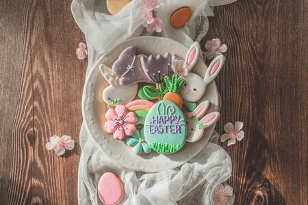 Happy Easter. Multi-colored pastel easter cookies on a wooden background. Easter conceptの写真素材