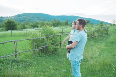Happy loving family. Father and his son baby boy playing and hugging outdoors. Concept of Fathers day.の写真素材