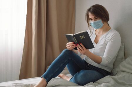 Coronavirus covid-19. The Woman holds a bible. Bible readings and prayer. Peace, hope concept.の写真素材