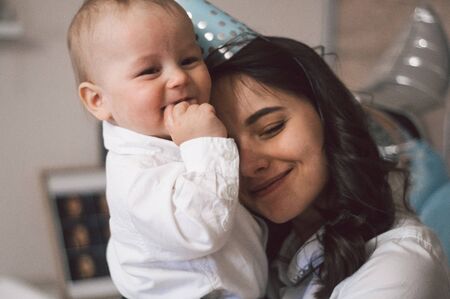 Woman hugging and playing with her little son on birthday. Mothers day, love, family, childhood...