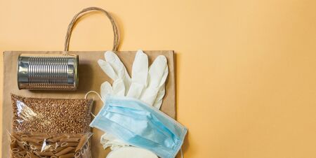 Food delivery, Donation, coronavirus. Buckwheat, pasta, canned food, mask and rubber gloves.の写真素材