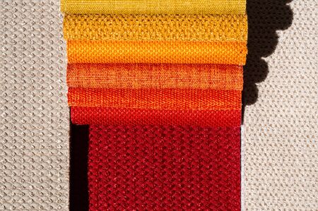 Catalog of fabric in yellow orange shades. Fabric sample. Industry background. Texture