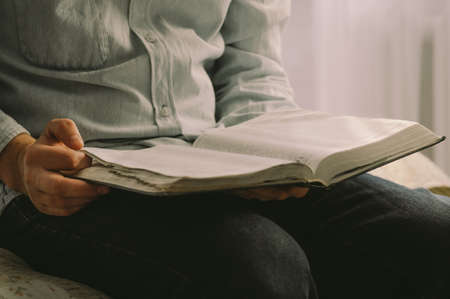 The Christian holds the Bible in his hands. Reading the bible. The concept of faith, spirituality...