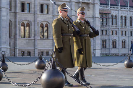 BUDAPEST, HUNGARY - APRIL 2020: Members of the Hungarian Guard of Honor marching around the Hungarian Parliament Building.のeditorial素材