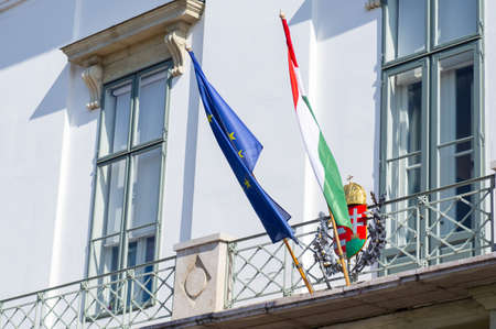 BUDAPEST, HUNGARY - APRIL 2020 : Hungarian flags on the Hungarian Presidential Sandor Palace of Budapest, a landmark and popular tourist destination in Budapest, Hungaryのeditorial素材