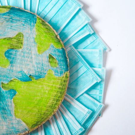 Planet Earth in a medical mask. The most sought after coronavirus covid-19 protection item in worldwide.の写真素材