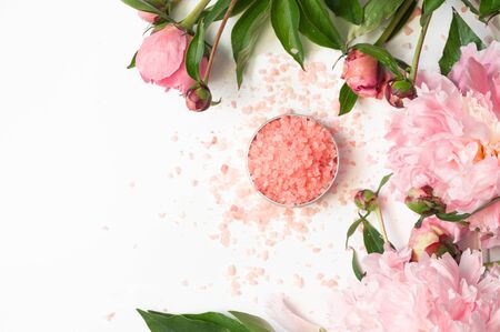 Natural organic cosmetic products with pink peonies flowers on white background. Spa relax Treatments and anti-cellulite massage. Beauty, nature cosmetics for bath spa, skin care, flat lay.の写真素材