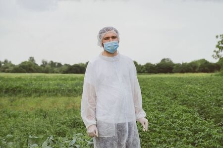 Man in protective suit, medical mask and rubber gloves for protect from bacteria and virus. Quarantine, world pandemic, COVID-19, coronavirus, infection.の写真素材