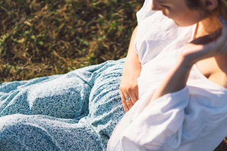Happy Attractive pregnant woman in outdoors. Concepts of pregnancy and family.