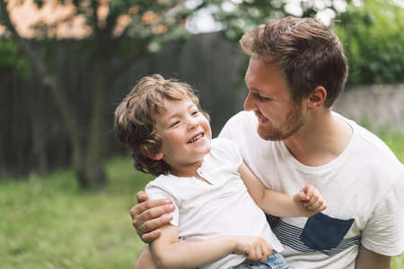 Father and his son playing and hugging in outdoors. Concept of Father's day. Happy loving family.の写真素材