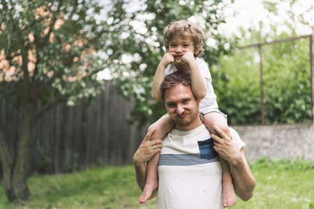Father and his son playing and hugging in outdoors. Concept of Father's day. Happy loving family.の写真素材