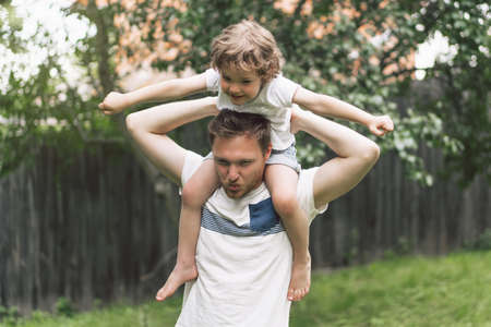 Father and his son playing and hugging in outdoors. Concept of Father's day. Happy loving family.の写真素材
