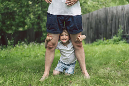 Father and his son playing and hugging in outdoors. Concept of Father's day. Happy loving family.の写真素材