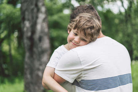 Father and his son playing and hugging in outdoors. Concept of Father's day. Happy loving family.の写真素材