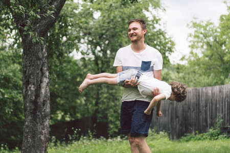 Father and his son playing and hugging in outdoors. Concept of Father's day. Happy loving family.の写真素材