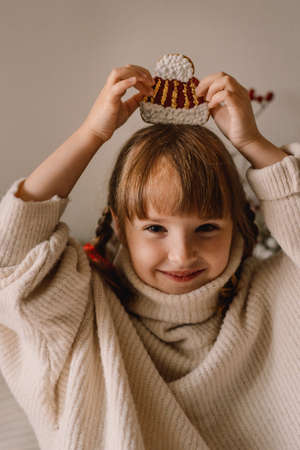 Merry Christmas and Happy Holidays. The child plays with gingerbread cookies. Waiting for Christmas.の写真素材
