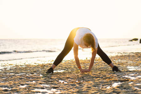 Young girl doing yoga fitness exercise outdoor in beautiful sea and morning sunrise. lifestyle....