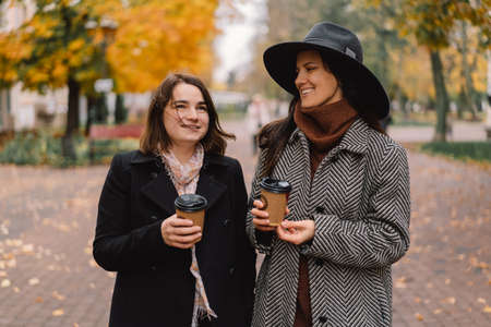 Girls drinking coffee in the park. Lifestyle.の写真素材