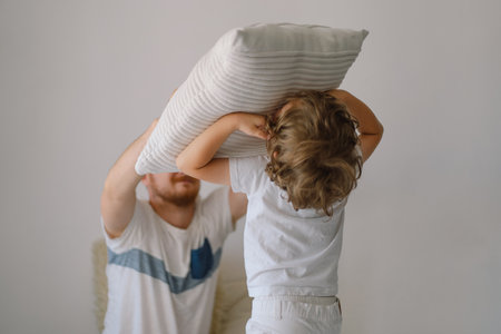 Father and his son are playing and hugging at home.の写真素材
