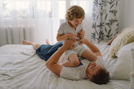 Father and his son are playing and hugging at home.の写真素材