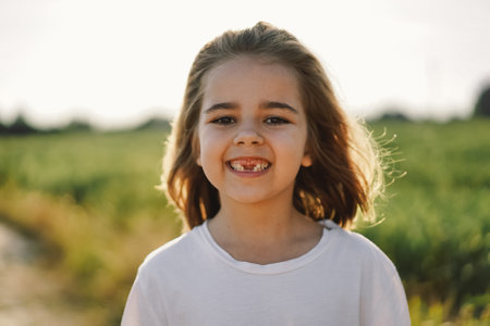 Happy child. Smiling child girl. Cheerful kid outdoors in nature.の写真素材