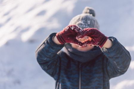 Joyful boy with red hearts on his face. Love conceptの写真素材