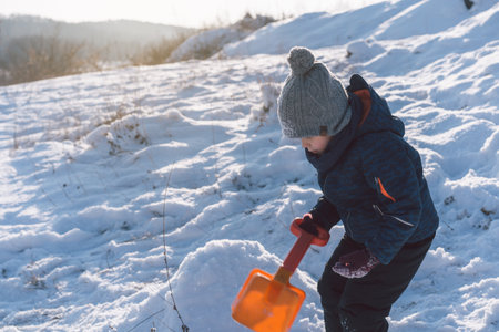 Little boy playing with snow. Winter holiday.の写真素材