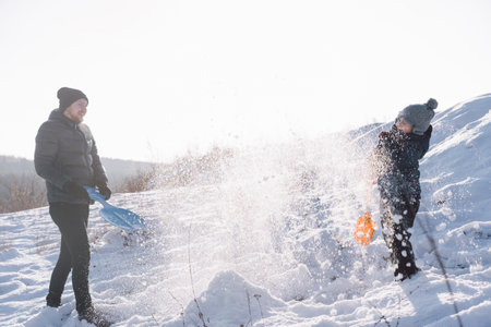 Happy dad and little boy playing with snow. Winter holiday.の写真素材