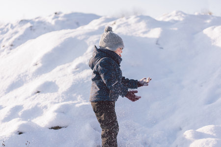 Little boy playing with snow. Winter holiday.の写真素材