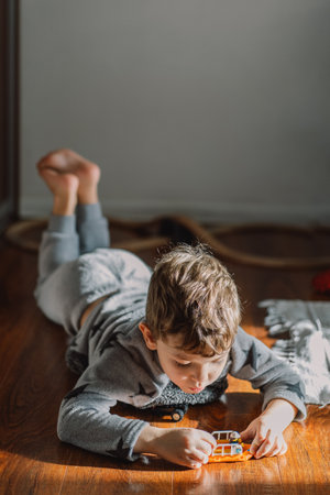 Little cute boy plays with toys at home.の写真素材