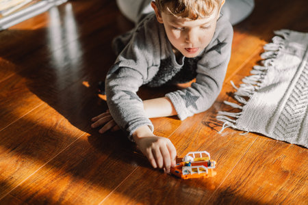 Little cute boy plays with toys at home.の写真素材